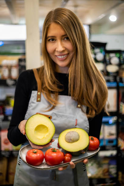 waiter cafe restaurant cooker female hands holding fresh farm avocado and tomatoes on metallic tray - guacamole food bar vegan food imagens e fotografias de stock