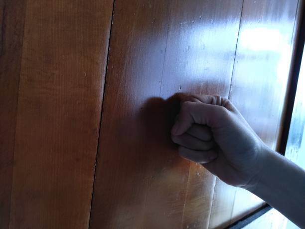 istock the hand hitting the door 1365269852