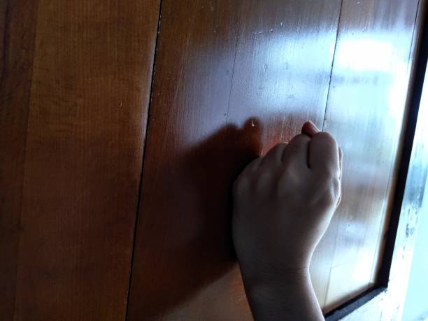 istock the hand hitting the door 1365269864