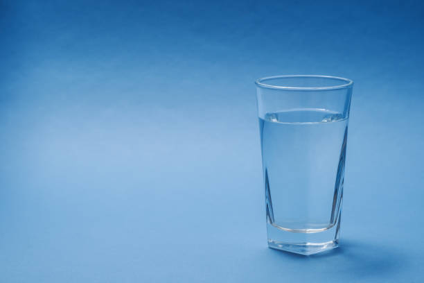 istock A glass of water on a blue background. 1365271969