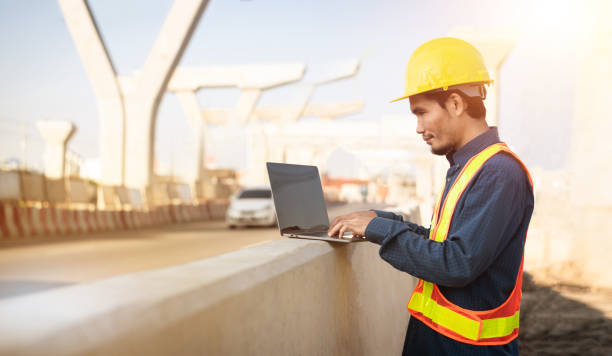 istock engineers use computers to check the quality and plan the construction of large expressways. 1365275383