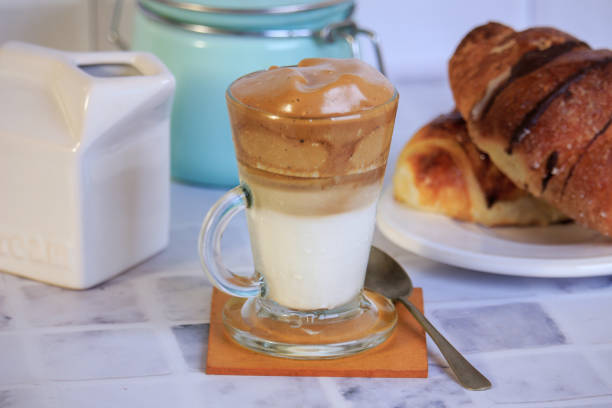 istock dalgona coffee in transparent cup and fresh croissant 1365278629