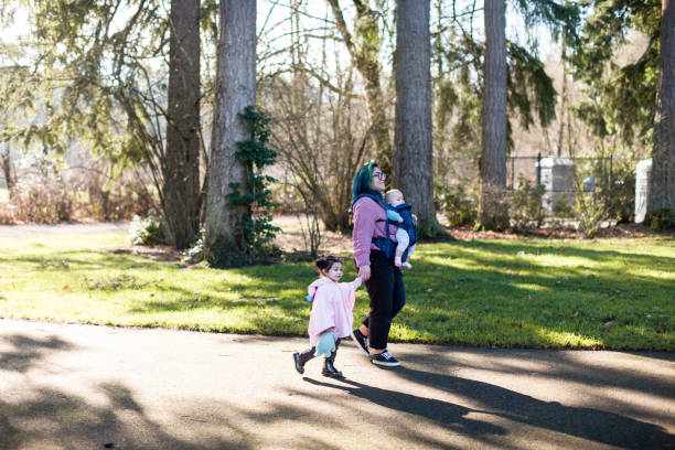 istock Family walking in a park together 1365278930