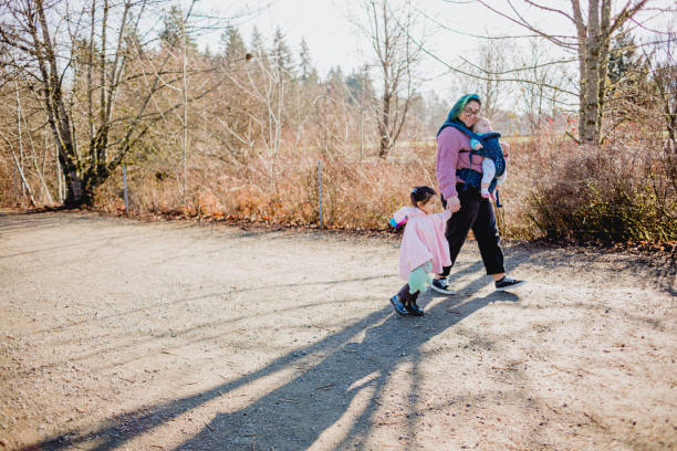 istock Family walking in a park together 1365279012