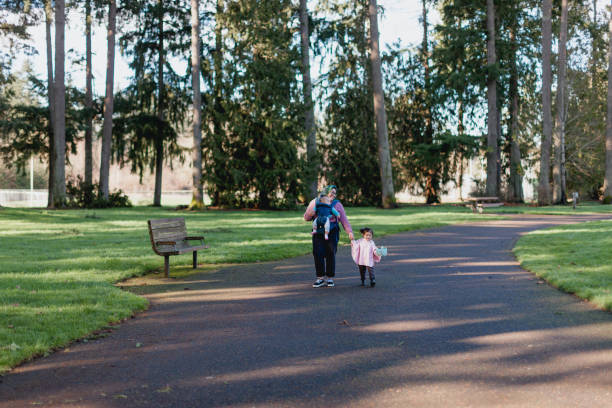 istock Family walking in a park together 1365279551