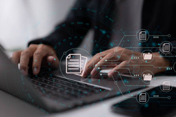 istock IT consultant is setting up a Document Management System (DMS). Archiving software for business files. Laptop computer in the office. 1365280627