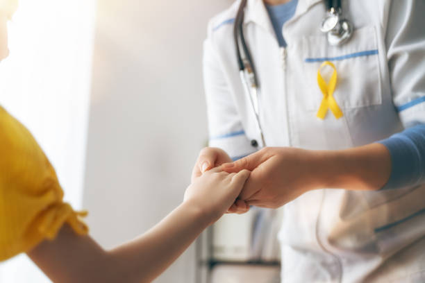 World Childhood cancer Day World Childhood cancer Day. Girl patient listening to a doctor in medical office. cancer stock pictures, royalty-free photos & images