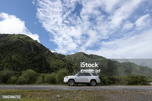 istock Driving off road car in high altitude forest mountains 1365286732