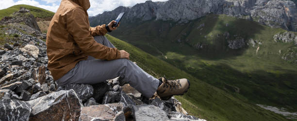 istock Hiker on high altitude mountain top enjoy the view 1365286787