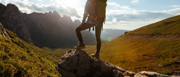 istock Solo woman backpacker hiking on alpine mountain peak 1365286872