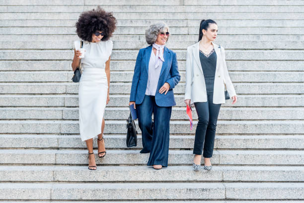 istock female executive workers walk down the stairs 1365287001