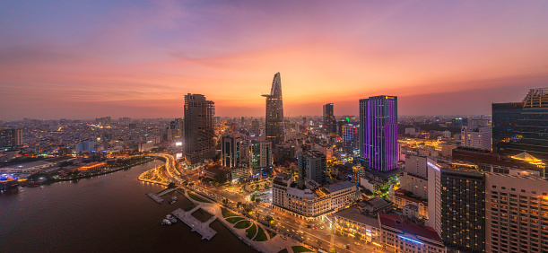Drone view of District 1 by Sai Gon river in Ho Chi Minh city in sunset, South Vietnam