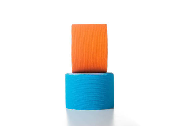 istock Blue and orange medical kinesiology tape on a white background. Isolate, teping, close-up 1365290734