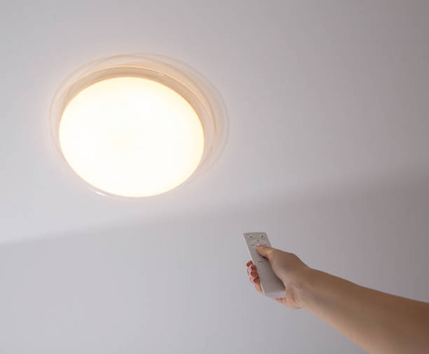 istock Modern LED ceiling chandelier with on off control panel. Adjusting the brightness of the lighting in the room, technologies. Sleep timer 1365290739