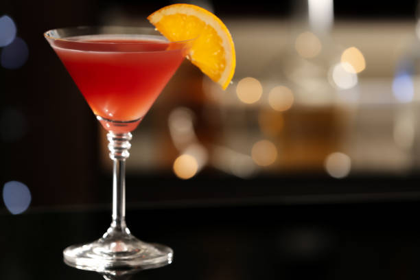 istock Delicious cocktail with orange on bar counter. Space for text 1365293939