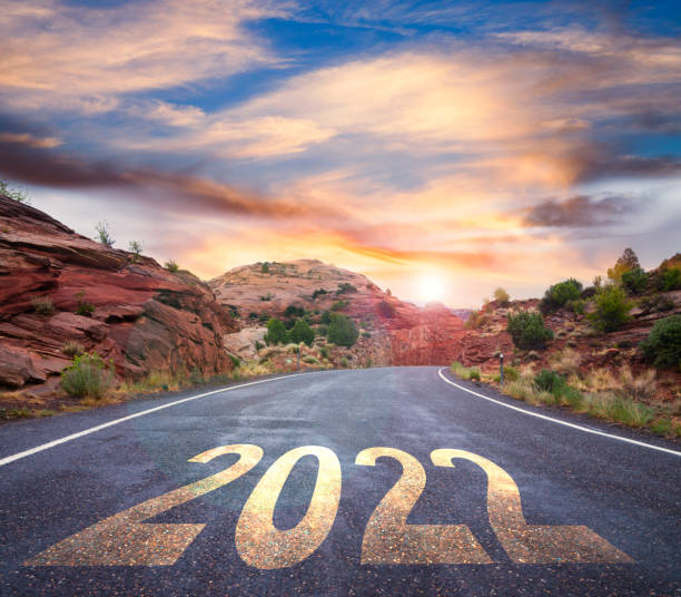 istock New Year 2022 ahead - empty road with 2022 road sign 1365294880