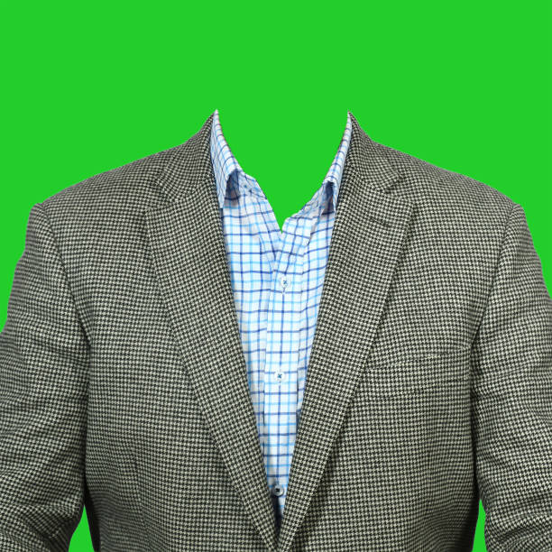 A grey men's suit with a blue plaid shirt. Clothes for photomontage on a green background.