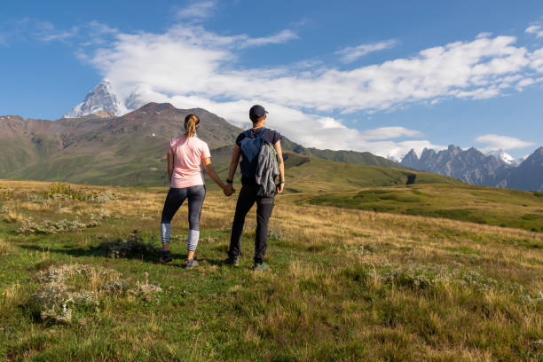istock Koruldi Lake Trek - Two hikers with panoramic view on Svaneti mountain range, Caucasus. 1365295800
