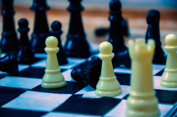 istock Chess pieces on chess board. Playing chess game at home. 1365297167
