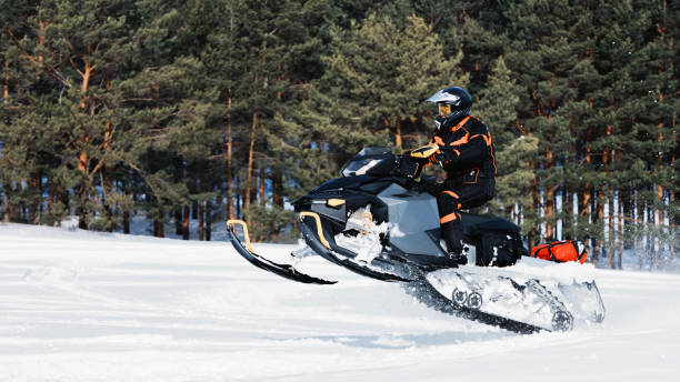 istock In deep powder snowdrift snowmobile rider driving fast. 1365297801