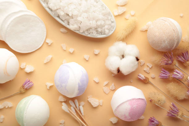 istock Aroma bath bombs in spa composition with dry flowers and salt on beige background. 1365302781