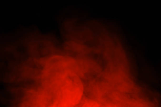 Abstract close-up of colorful red mist or steam smoke. isolated on black background in mysterious darkness copy space