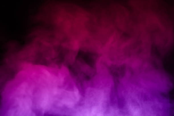 close-up of floating colorful steam smoke spray isolated on a black background