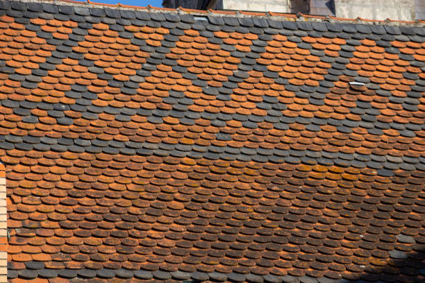istock Seamless roof texture of flat red shingles with embedded line patterns 1365305399