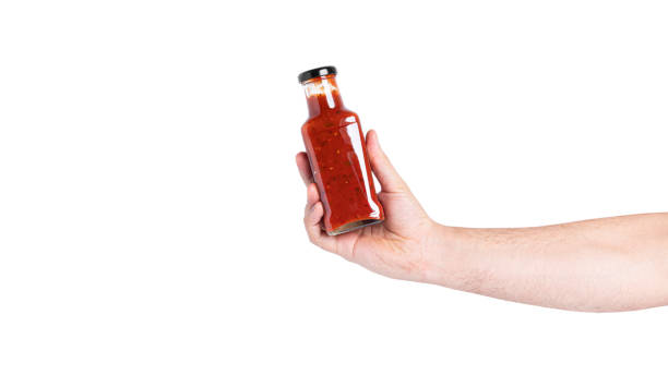 istock Sauce in a bottle isolated on a white background. Bottle in hand 1365305760