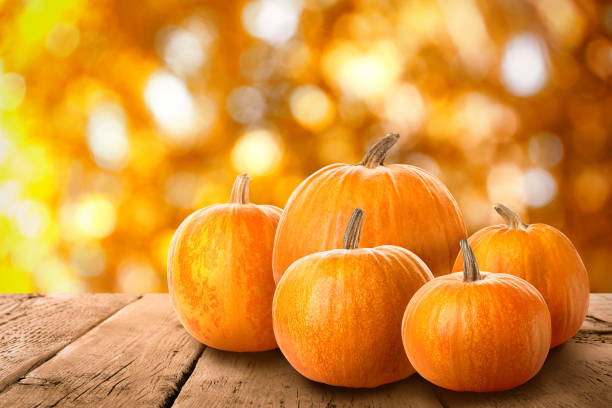 istock Fresh pumpkins on wooden table outdoors in autumn 1365308579