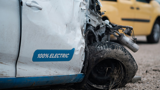 Crashed electric car in severe accident, frontal impact. Safety idea