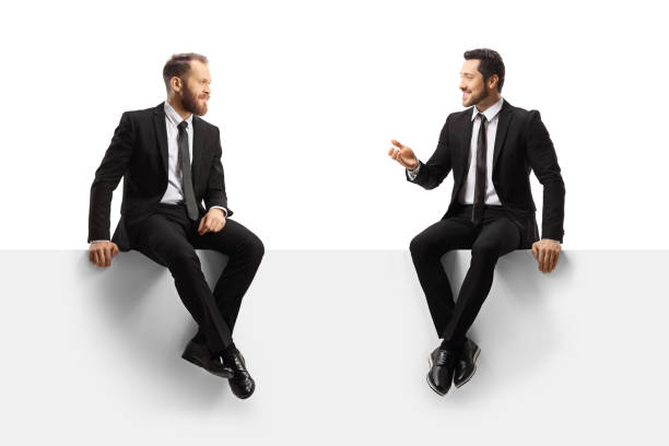istock Professional men in suits sitting on a panel and having a conversation 1365310617