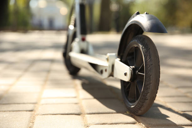 istock Modern kick scooter outdoors on sunny day, closeup. Space for text 1365312090