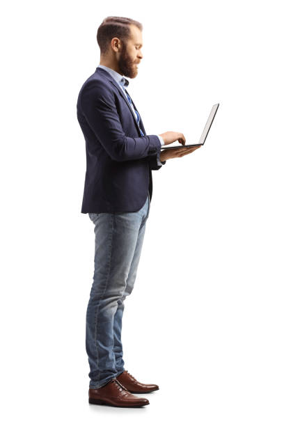 istock Full length profile shot of a man holding a laptop computer 1365312140