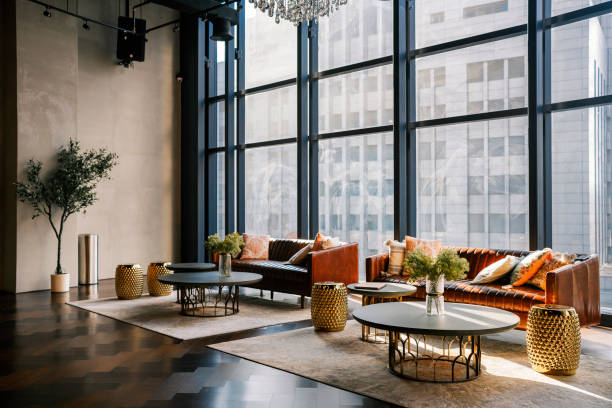 istock lounge with sofa , carpet and coffee table against window with city view lobby area 1365312361