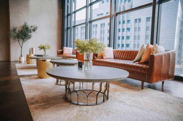istock lounge with sofa , carpet and coffee table against window with city view lobby area 1365312368