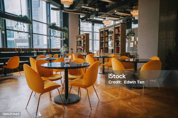 Modern Cafe Restaurant Interior With Yellow Chair Against Window With City View Stock Photo - Download Image Now