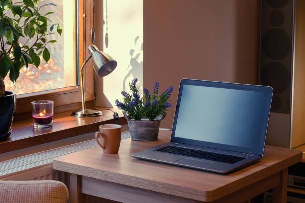 istock Home working place with laptop. Cozy home interior in the warm window light. 1365312487