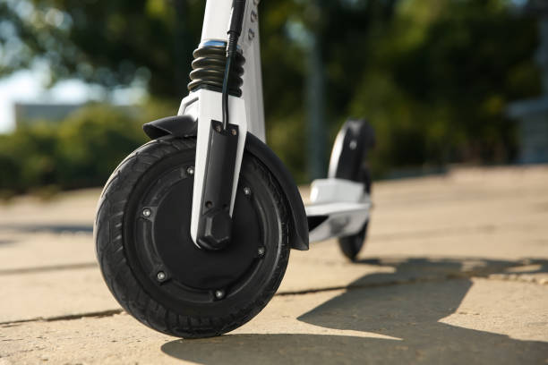istock Modern electric kick scooter outdoors on sunny day, closeup 1365312543