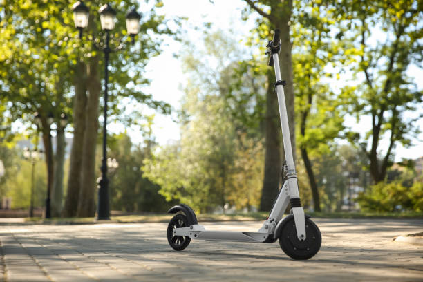 istock Modern electric kick scooter outdoors on sunny day 1365312913