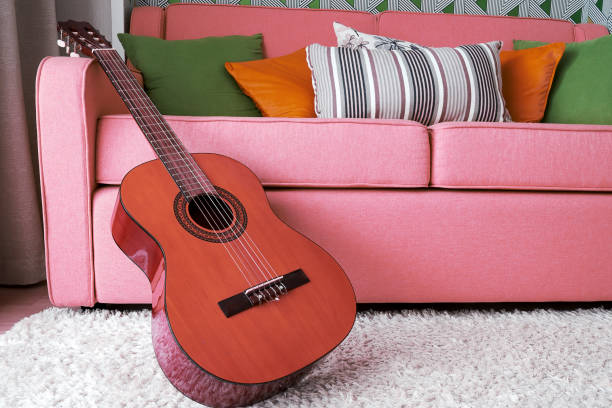 istock Classic acoustic guitar in the pink interior 1365314314