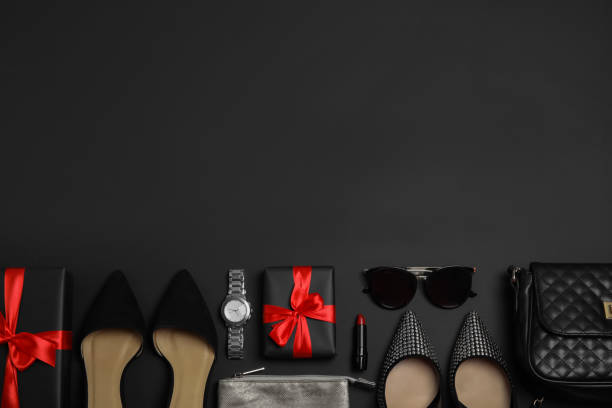 istock Gift boxes, shoes and stylish women's accessories on black background, flat lay. Space for text 1365314346