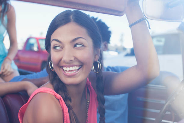 istock Smiling woman sitting in car 1365314654