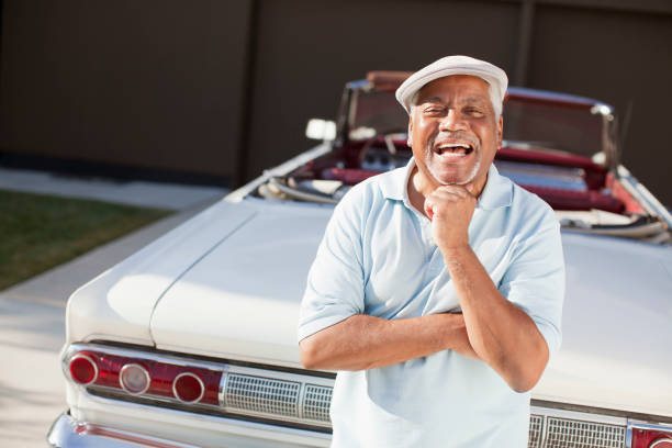 Older man smiling with convertible stock photo