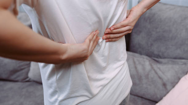 istock Pregnant Woman's hands massaging her back pain. 1365314861