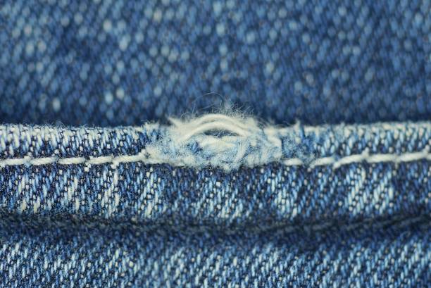 istock a piece of blue denim pants with white threads 1365315517