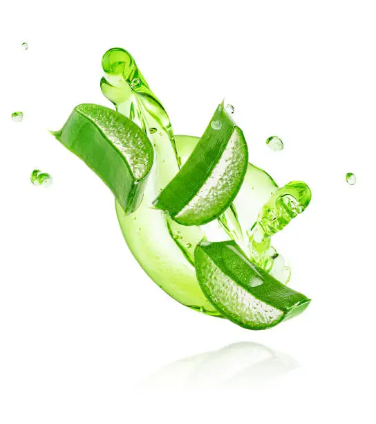 Photo of Green gel flowing with aloe vera slices isolated on white background