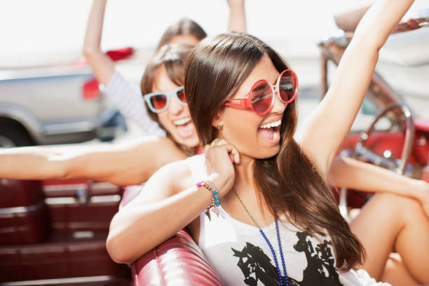 istock Women cheering in convertible 1365315721
