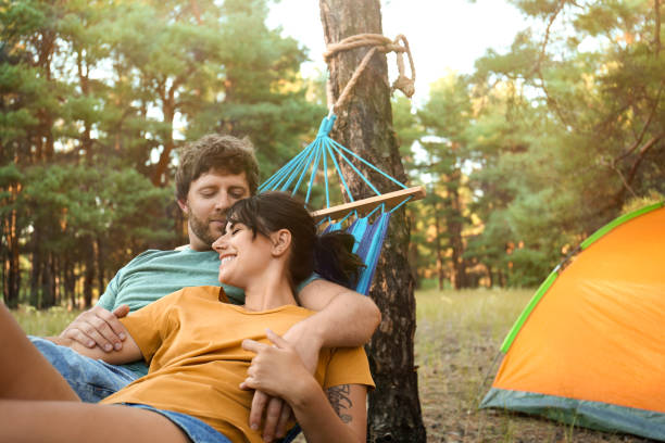 istock Lovely couple resting in comfortable hammock outdoors 1365315733