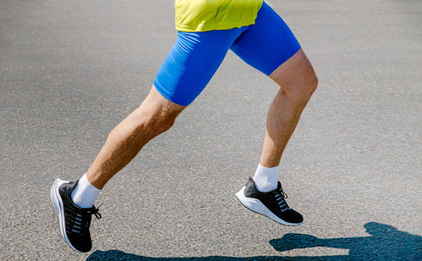 istock legs male runner running on asphalt road 1365316322
